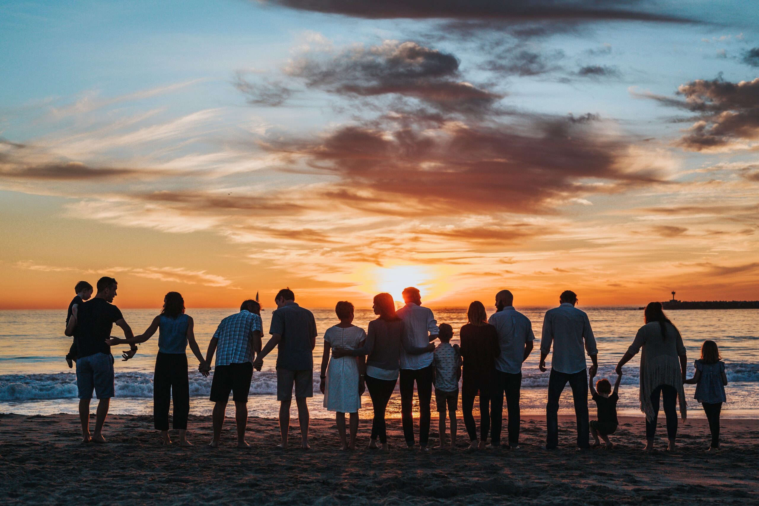 Group at the beach, watching the sunset.